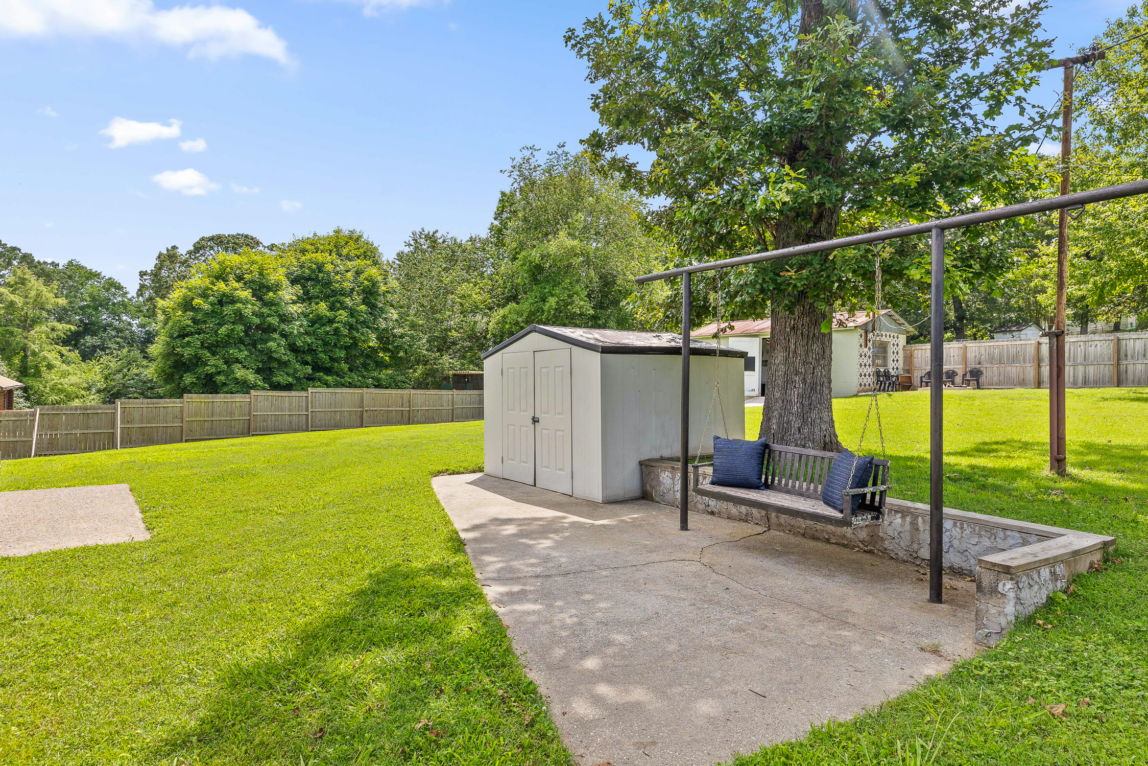 Backyard with swing set and spacious lawn